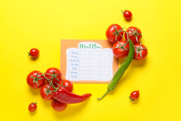 Fresh vegetables with meal plan on yellow background - Photo, Image