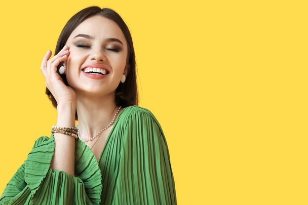 Happy woman with trendy accessories on color background - Photo, Image
