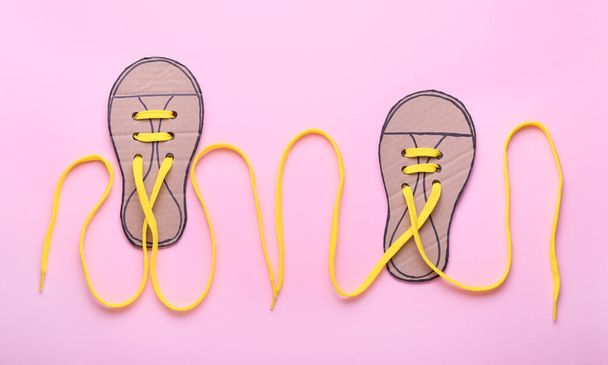 Shoe lacing cards with laces on pink background - Photo, Image
