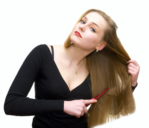Молода дівчина розчісує волосся
 - Фото, зображення