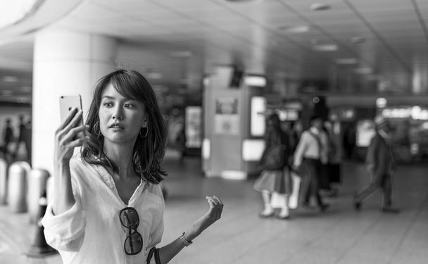 Young asian girl making selfie with smartphone inside subway. - Fotografie, Obrázek