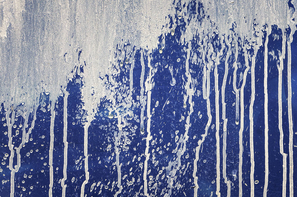 Drips and stains of white paint on blue wall. Grunge textured background.       - Zdjęcie, obraz