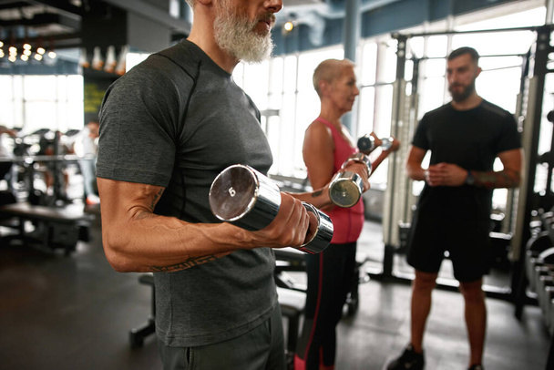 Keeping fit after retirement concept. Elder muscular man portrait - Photo, image