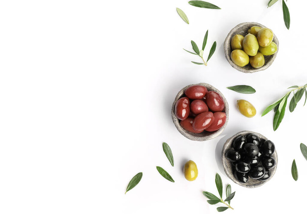 Green, red and black olives in bowls isolated on white background - Photo, Image