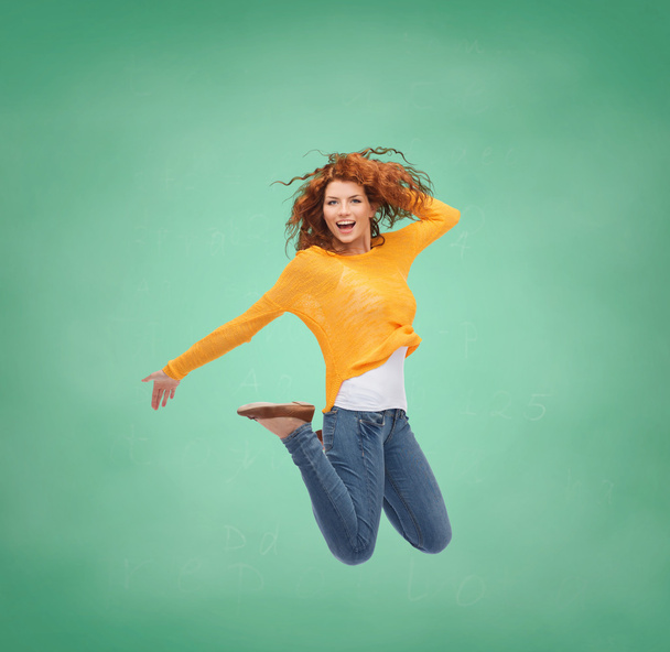 smiling young woman jumping in air - Fotografie, Obrázek