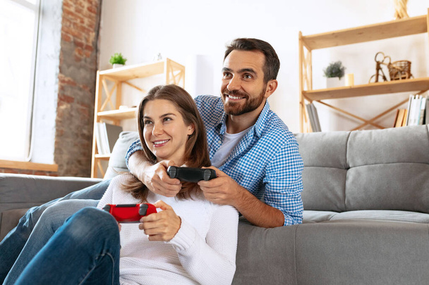 Smiling married couple spending time together at home, indoors. Middle aged couple sitting together. Concept of family, relationship - Foto, Imagem