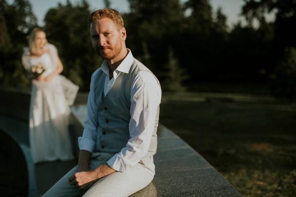 Closeup of the young newlywed man sitting in front of his young bride - Fotoğraf, Görsel
