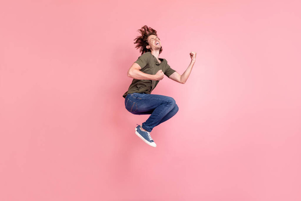 Full length profile side photo of young man jump celebrate victory shocked win lottery isolated over pink color background - Fotografie, Obrázek