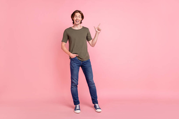 Full length photo of young guy happy positive smile point finger empty space promo advertise direct isolated over pink color background - Foto, Imagen
