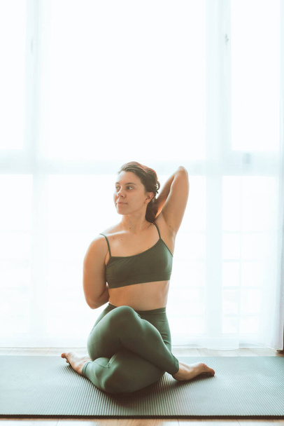 woman do yoga at home near big window healthy lifestyle - Фото, изображение