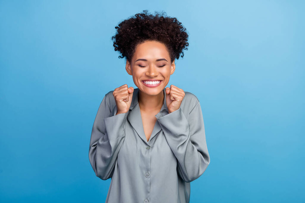 Photo of young cheerful afro girl celebrate success achievement ecstatic hooray isolated over blue color background - Foto, immagini