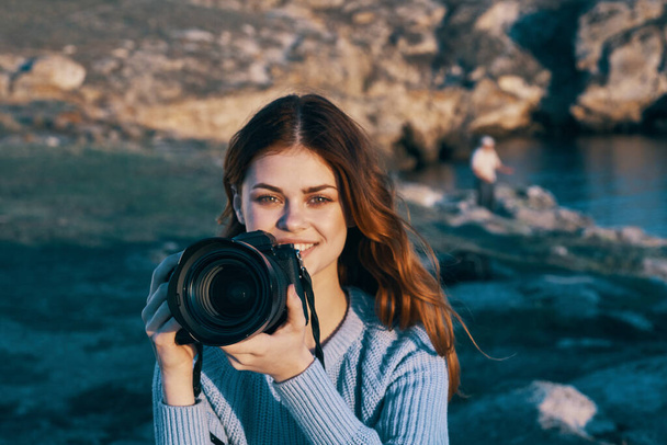 woman with camera in nature taking pictures of landscape  - Photo, Image