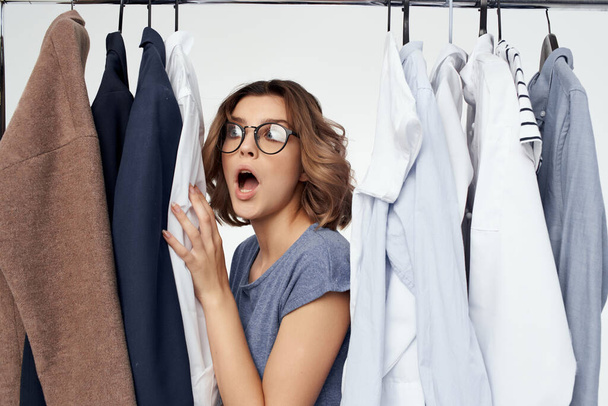 emotional woman with glasses selectiing  clothes - Photo, Image