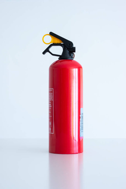Small portable car fire extinguisher. Close up studio shot, isolated on white, no people. - Photo, Image