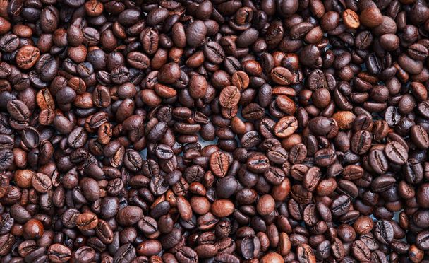 Brown and black coffee beans. Roasted arabic espresso coffee grains. - Photo, Image