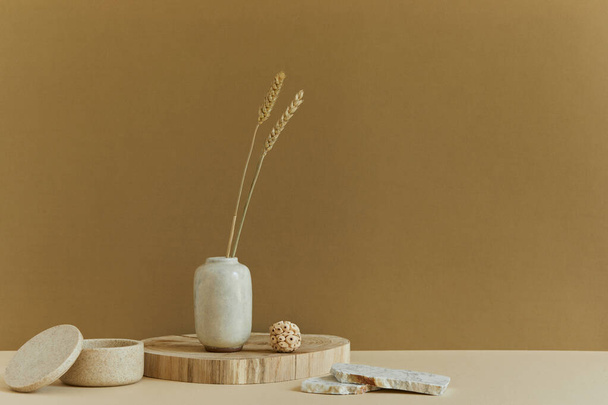 Stylish minimalistic interior design with copy space, natural materials as wood and marbel, dry plants and personal accessories. Neutral and yellow colors, template. - Photo, Image