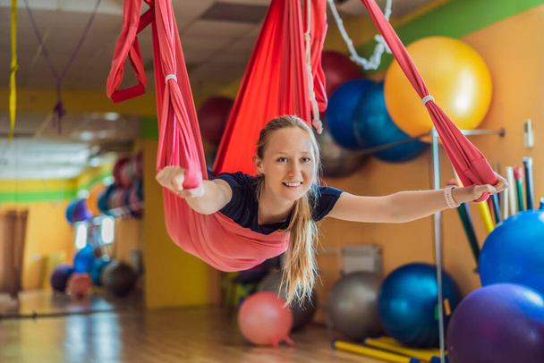 Young beautiful woman practicing aerial yoga in gym. Lifestyle - Fotoğraf, Görsel