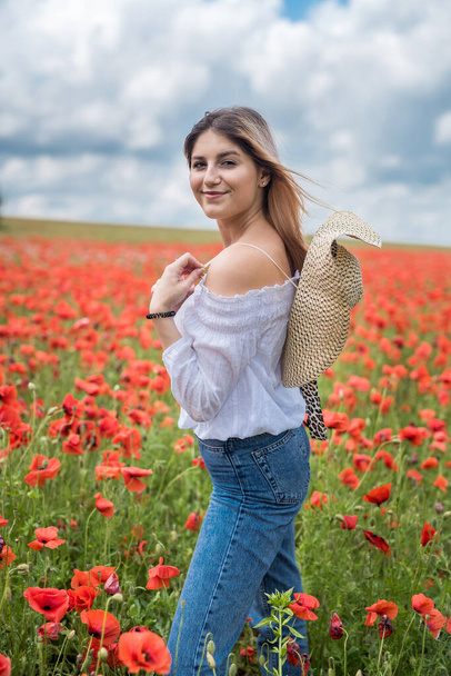 Caucasian model enjoy life at poppy field, sunny day. health lifestyle - Fotó, kép