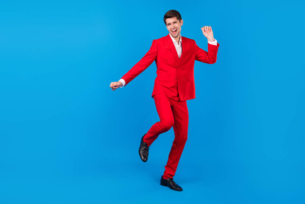 Full size photo of young man happy positive smile have fun dance party isolated over blue color background - Φωτογραφία, εικόνα