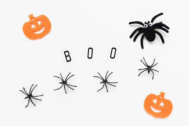 Pumpkins, spiders and text BOO on white background - Фото, зображення