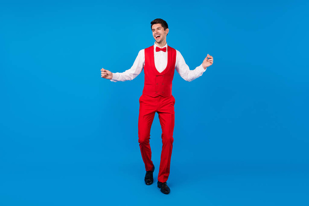 Full length photo of young man happy positive smile have fun event party isolated over blue color background - Zdjęcie, obraz
