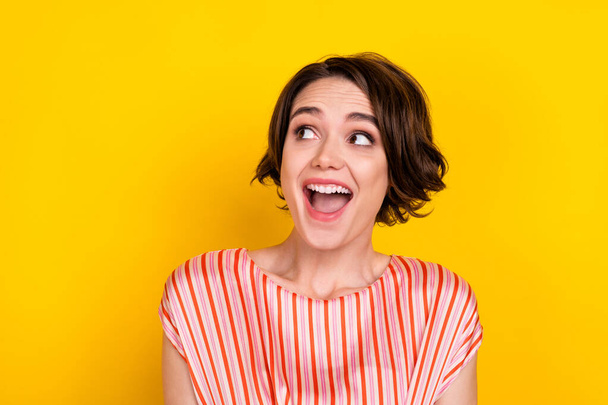 Portrait of attractive curious cheerful brown-haired girl cool news reaction copy space isolated over bright yellow color background - Zdjęcie, obraz
