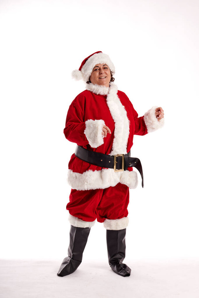 A middle-aged woman in a Santa Claus costume with a white background - Fotografie, Obrázek