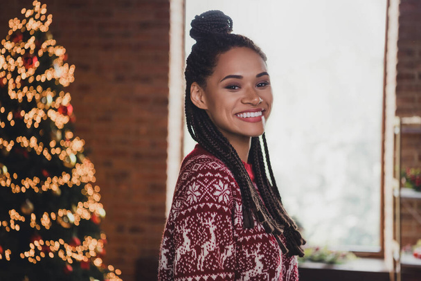 Photo of charming positive african lady beaming smile enjoy x-mas eve wear jumper in decorated home indoors - Φωτογραφία, εικόνα