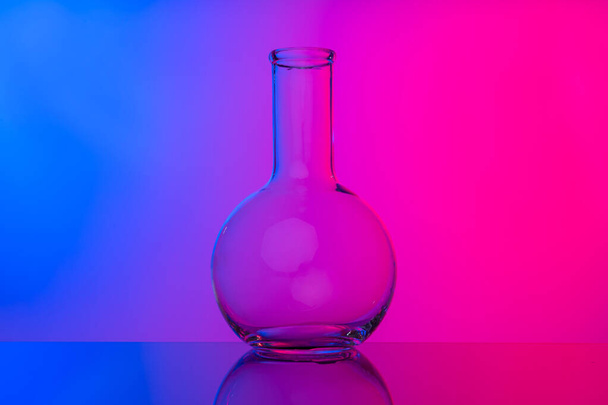 Chemical glassware close up on neon pink-purple background - Photo, Image
