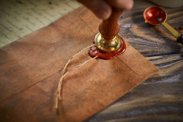 Sealing wax on ancient papers, antique stamp, and old documents, brass spoon  - Fotoğraf, Görsel
