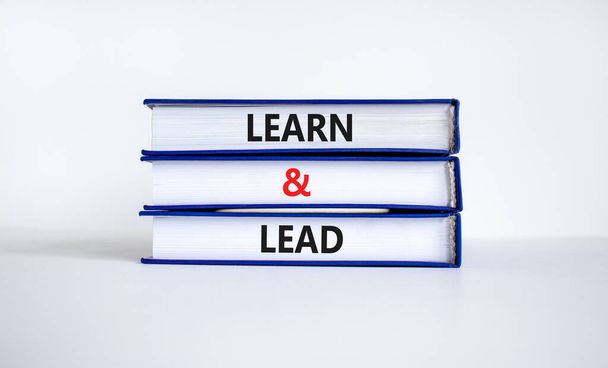 Learn and lead symbol. Concept words 'Learn and lead' on books. Beautiful white background. Business, educational and learn and lead concept, copy space. - Fotó, kép