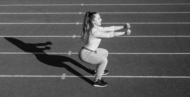 girl kid training sport with barbells outside on stadium arena, strength - Valokuva, kuva