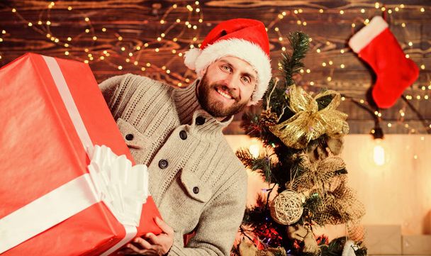Look at that. christmas shopping sales. what a surprise. new year gift. man hols huge gift. home gift delivery. happy man with beard santa hat. present for you. only my - Foto, Bild