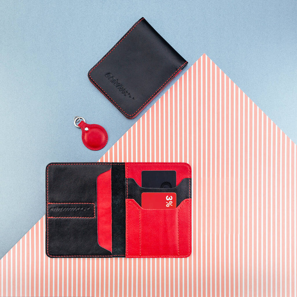 Black and red stylish leather purse for driver's license, passport or id card. Documents cover and holder. Flat lay. Trinket for keys. Trendy accessories concept. Blue and scarlet striped background. - Foto, immagini