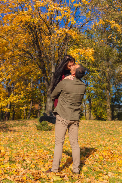 Lovely couple having fun together in nature. Boyfriend carrying his girlfriend in his arms. Holidays, love, travel, tourism, relationship and dating concept. - 写真・画像