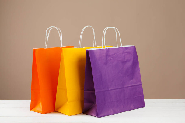 Arrangement of shopping bags on beige background - Foto, imagen
