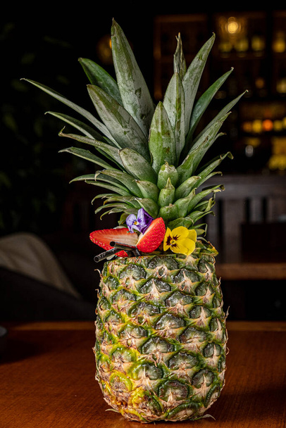 Pina Colada in Pineapple with strawberries and straws - Fotoğraf, Görsel