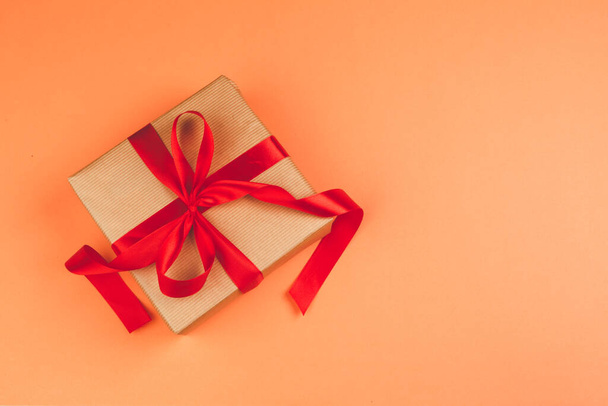 Present with a bow on orange background - Photo, Image