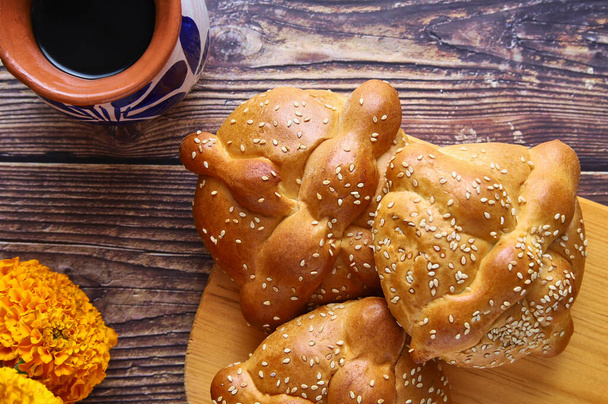 Pan del Muerto, bread from the Day of the Dead in Mexico traditionally decorated with the marigold flower. - Photo, Image