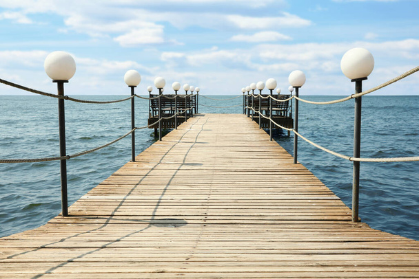 Beautiful river scene with wooden pier on sunny day - Fotoğraf, Görsel