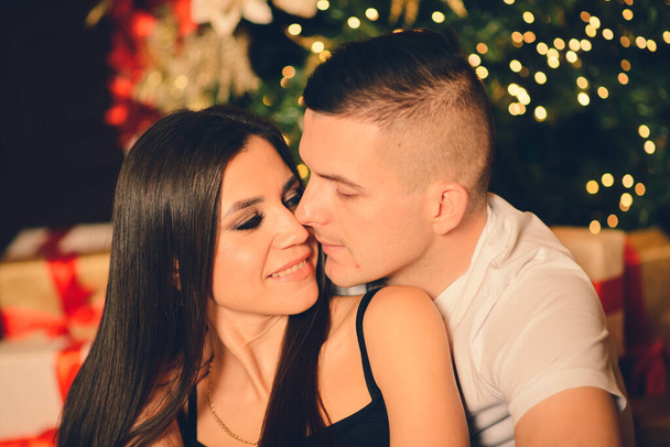 Man surprise woman for Chrismas, loving and kissing couple - Foto, immagini