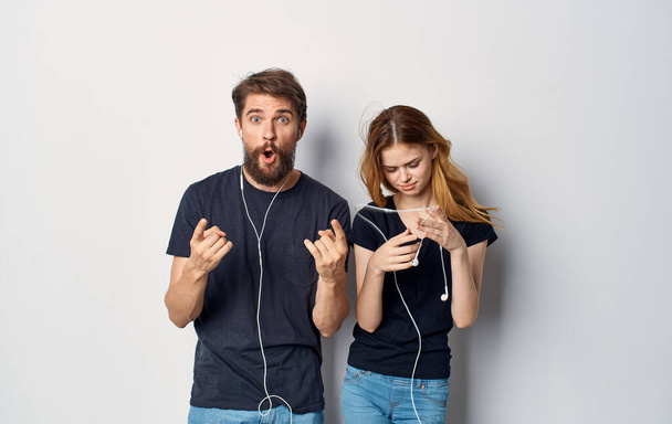 Man and woman in black t-shirts phone fun together friendship Studio Lifestyle - Φωτογραφία, εικόνα