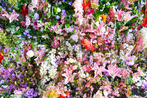 fake many flower in the wall background - Photo, Image