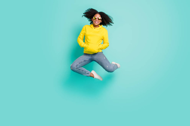 Full length body size photo woman jumping up wearing casual clothes isolated bright teal color background - Fotoğraf, Görsel