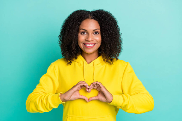 Photo portrait curly woman showing heart shaped sign isolated bright teal color background - Foto, imagen