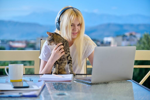 Female student studies at home online using a laptop - 写真・画像
