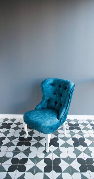 Modern design home interior with elegant blue chair in retro style over gray wall. Stylish home decor - Valokuva, kuva