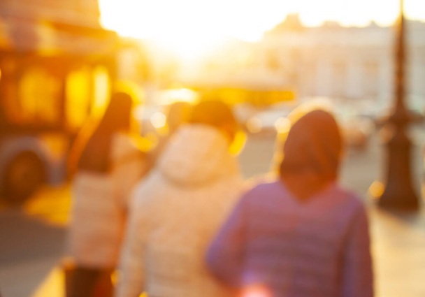 Blurred silhouette of four people at the golden hour in the city. - Photo, Image
