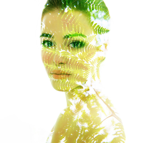 Beautiful young female face with summer fern leaves, double exposure. Beauty treatment, youth, summer and nature concept - Valokuva, kuva