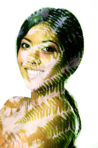 Porträt einer jungen schönen lächelnden asiatischen Frau mit sommerlichen Farnblättern, Doppelbelichtung. Schönheitsbehandlung, Jugend, Naturkonzept - Foto, Bild